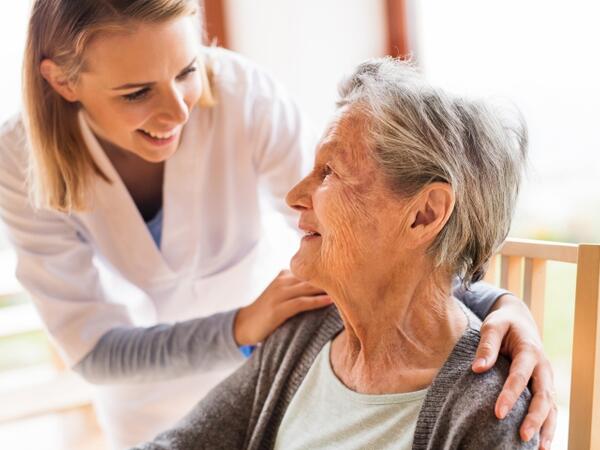 nurse and senior citizen smiling