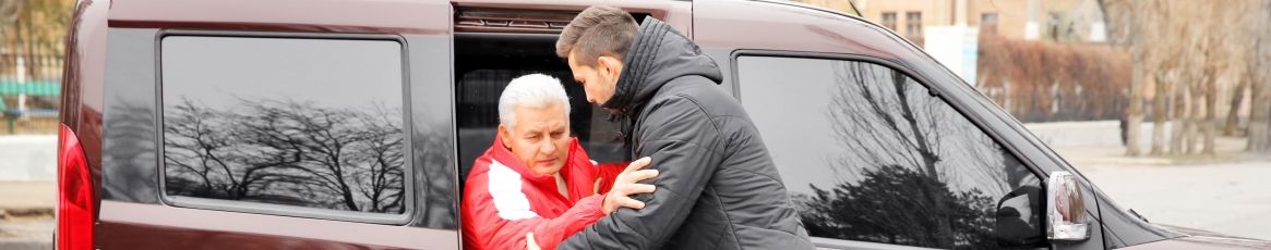 a person helping senior citizen