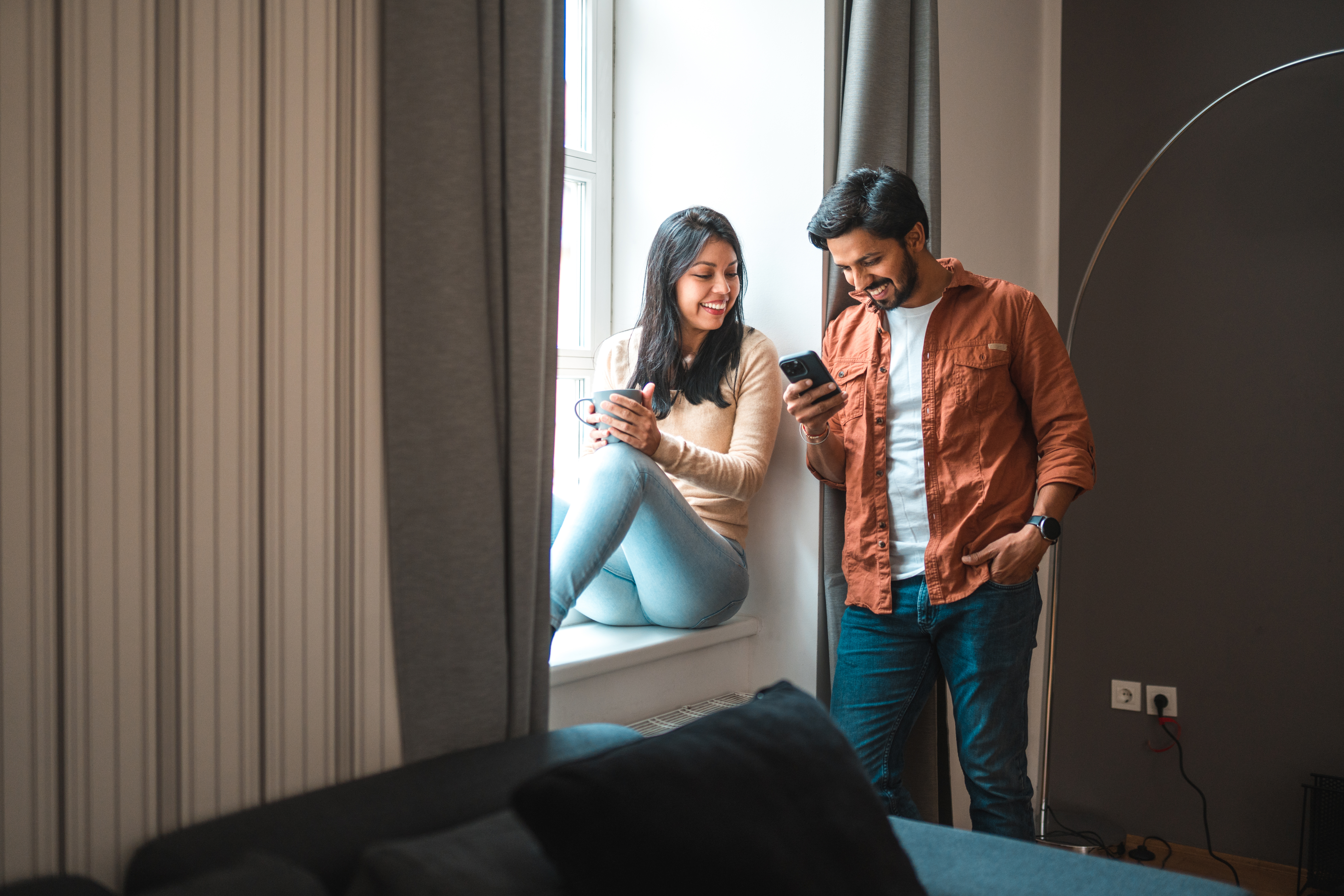 Two people glare at their smartphones and look at the ASU CIC blogs.