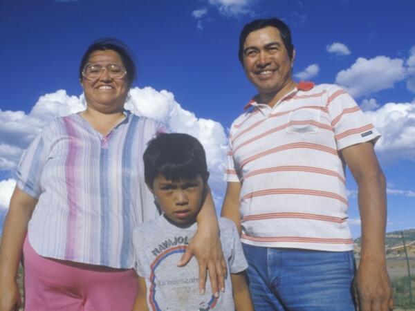family standing and posing with sky background