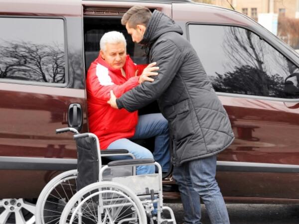 person helping an old woman